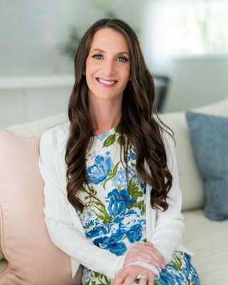 Dr. Emily L. Wald, Ph.D., smiling in a sunlit room.